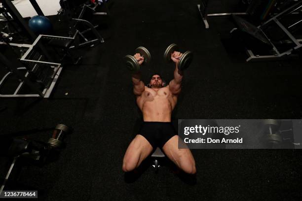 Chris Kavvalos performs a dumbbell fly press during a workout at City Gym on May 24, 2020 in Sydney, Australia. IFBB body builder Chris Kavvalos has...