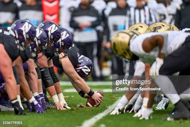 Northwestern Wildcats offensive line lines up across from the Purdue Boilermakers defensive line at the line of scrimmage during a game between the...