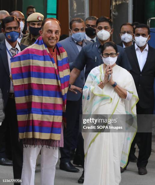 Trinamool Congress supremo and West Bengal Chief Minister, Mamata Banerjee wearing a white saree poses for a picture with BJP leader and Rajya Sabha...