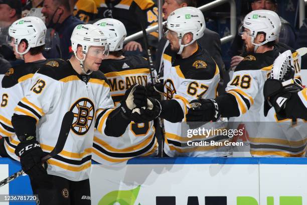 Charlie Coyle of the Boston Bruins celebrates his first period goal with teammates on the bench during an NHL game against the Buffalo Sabres on...