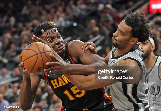 Clint Capela of the Atlanta Hawks fights off Keita Bates-Diop of the San Antonio Spurs in the first half at AT&T Center on November 24, 2021 in San...