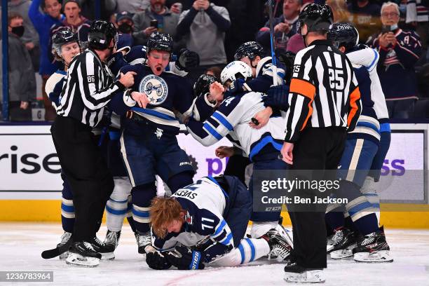 Max Domi of the Columbus Blue Jackets reacts as he looks at Evgeny Svechnikov of the Winnipeg Jets down on the ice during the third period at...