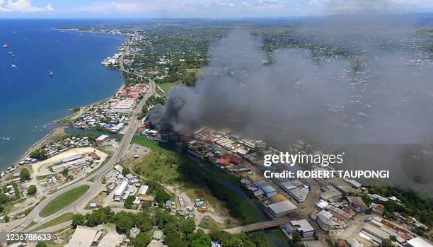 Smoke from burning buildings rise from Honiara on the Solomon Islands on November 25 on the second day of rioting that left the capital ablaze and...