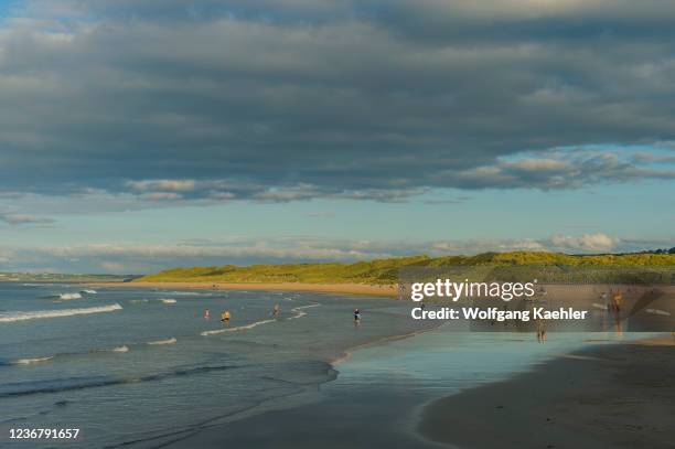 View of West Strand beach with swimmers at Portrush, County Antrim, Northern Ireland, United Kingdom.