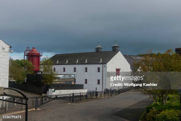 View of the Bushmills Whiskey Distillery in Bushmills, County Antrim, Northern Ireland, UK, which was granted a license to distill in 1608, and is...