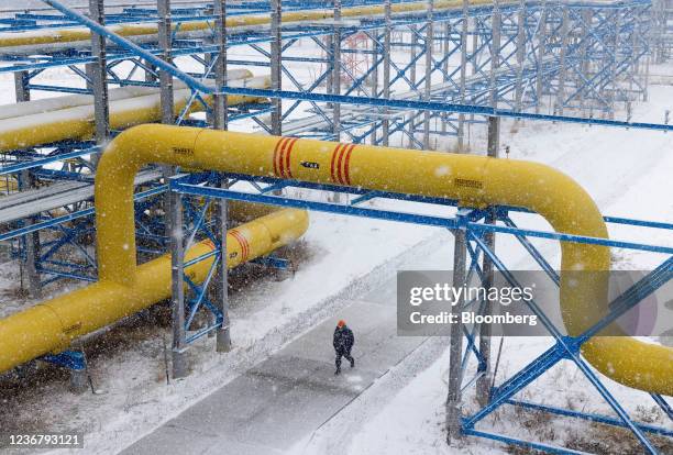 Bloomberg Best of the Year 2021: A worker walks under pipework in the yard at the Comprehensive Gas Treatment Unit No.3 of the Gazprom PJSC...