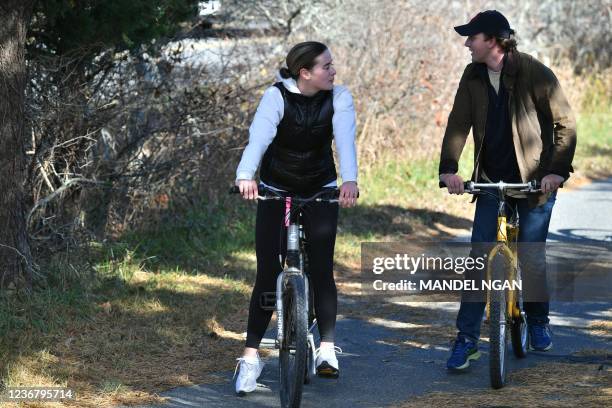 Naomi Biden the granddaughter of US President Joe Biden and her fiancé Peter Neal ride bikes in Nantucket, Massachusetts on November 23, 2021. Biden...