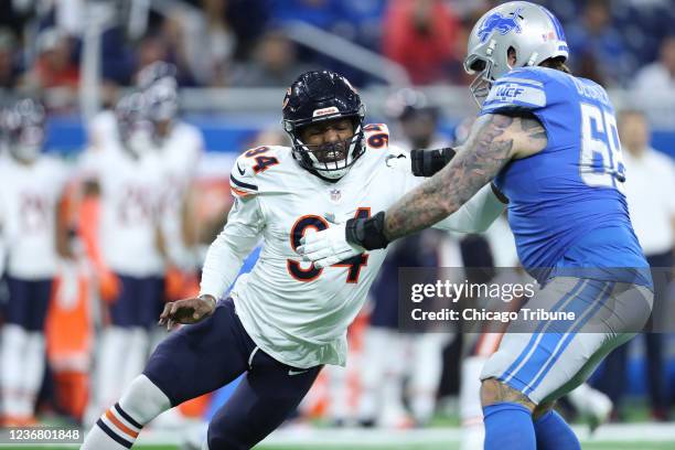 Chicago Bears outside linebacker Robert Quinn is blocked by Detroit Lions offensive tackle Taylor Decker in the first quarter at Ford Field, Thursday...