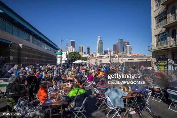 Homeless people eat the Thanksgiving meal served by the nonprofit Midnight Mission to nearly 2,000 homeless people in the Skid Row neighborhood of...