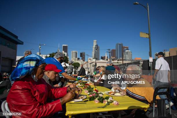 Homeless people eat the Thanksgiving meal served by the nonprofit Midnight Mission to nearly 2,000 homeless people in the Skid Row neighborhood of...