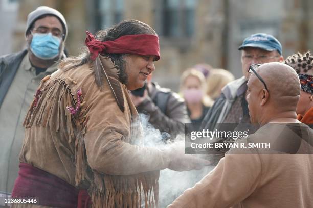 Julio Whitewolf of the Seminole and Taino tribes performs a smudging ceremony at the National Day of Mourning, on Thanksgiving day, November 25, 2021...