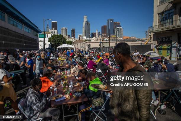 Homeless people eat the Thanksgiving meal served by the nonprofit Midnight Mission to nearly 2,000 homeless people in the Skid Row neighborhood of...