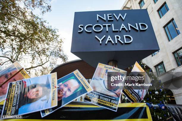 Images of victims of male violence are pictured outside New Scotland Yard during a vigil by dozens of supporters of Million Women Rise to mark the...