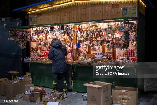 Saleswoman of Christmas crafts is seen placing pieces in her cabin store. Barcelona is preparing the Fira de Santa Llúcia, a traditional outdoor...