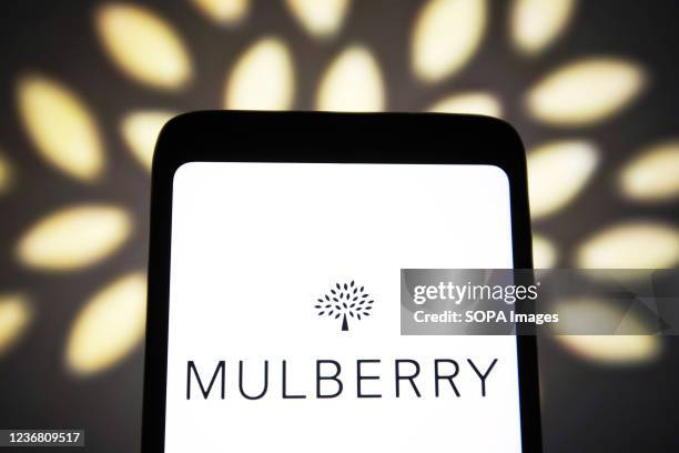 In this photo illustration, a Mulberry Group plc logo of a a luxury fashion company is seen on a smartphone screen.