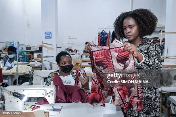 Joselyne Umutoniwase, fashion designer and entrepreneur, and also founder of Rwanda Clothing, inspects production of her collection in Kigali on...