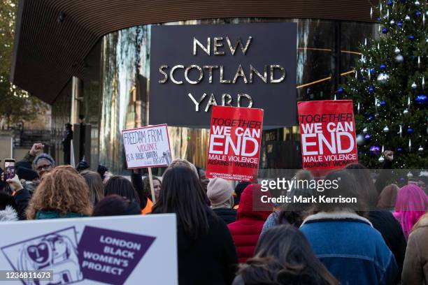 Dozens of supporters of Million Women Rise attend a vigil outside New Scotland Yard to remember the victims of male violence against women on the...