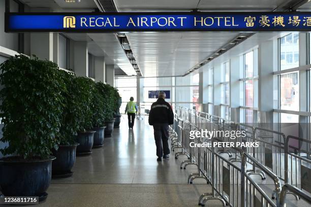 People head towards the Regal Airport Hotel at Chek Lap Kok airport in Hong Kong on November 26 where a new Covid-19 variant deemed a 'major threat'...