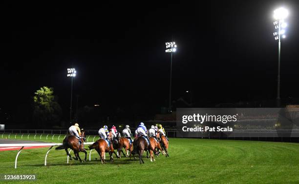 Horses round the first turn during the running of the TOTE Bar & Dining Handicap at Moonee Valley Racecourse on November 26, 2021 in Moonee Ponds,...