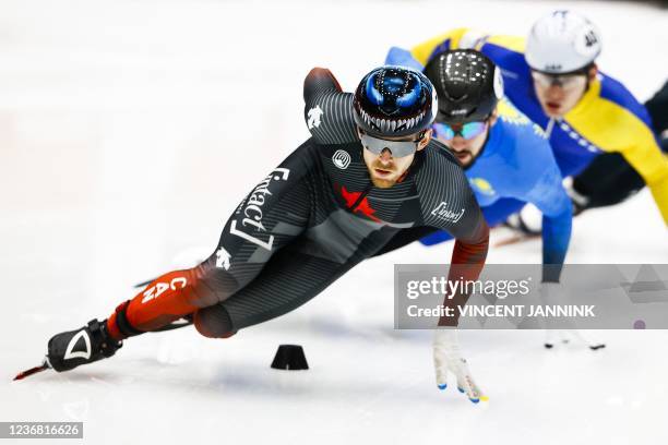 Canada's Pascal Dion, Kazakhstan's Denis Nikisha and Bosnia and Herzogovina's Tarik Omeragic compete during the preliminaries of the 1000 meters...