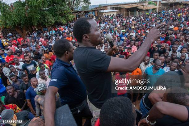 Former lawmaker Bon Kalindo gestures as he leads demonstrators in Lilongwe on November 26, 2021. - Police in Malawi fired teargas to disperse...