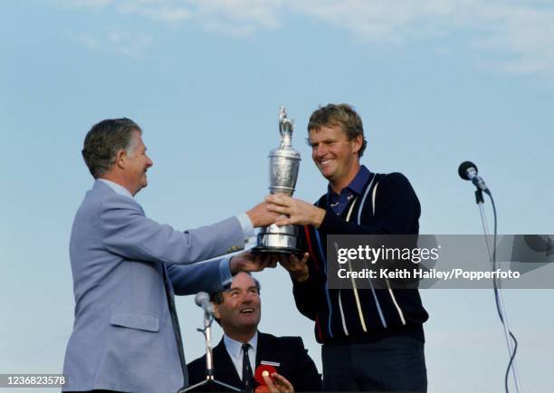 Sandy Lyle of Scotland receives the Claret Jug during the presentation after winning the 114th Open Championship at Royal St George's Golf Club on...