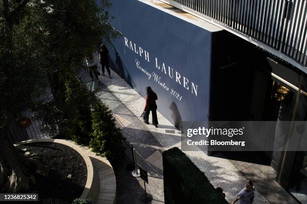 Shoppers walk past an unopened Ralph Lauren store on Black Friday at the Westfield Century City shopping mall in Los Angeles, California, U.S., on...