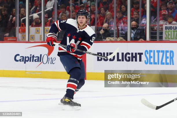 Dennis Cholowski of the Washington Capitals makes a pass during a game against the Florida Panthers at Capital One Arena on November 26, 2021 in...