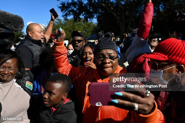 People react outside the Glynn County Courthouse after jurors found the three men guilty in the Ahmaud Arbery trial on November 24, 2021 in...