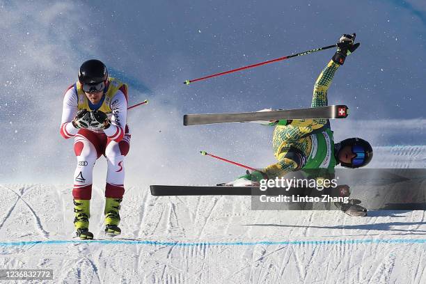 Tobias Mueller of Germany falls as Johannes Aujesky of Austria competes in the Men's Ski Cross of Audi FIS Cross World Cup 2022 at Genting snow park...