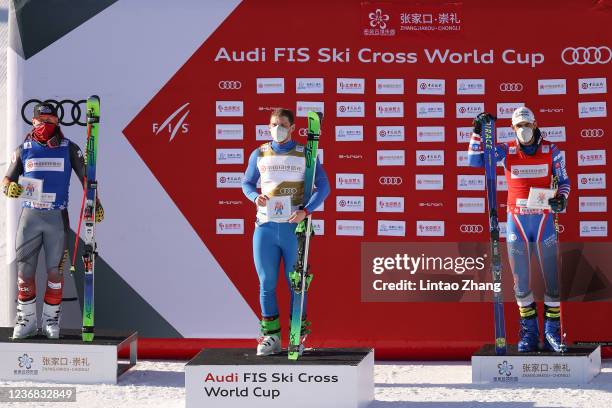 Second-placed Brady Leman of Canada, winner Sergey Ridzik of Russia and third-placed Bastien Midol of France celebrate on the podium after the Men's...