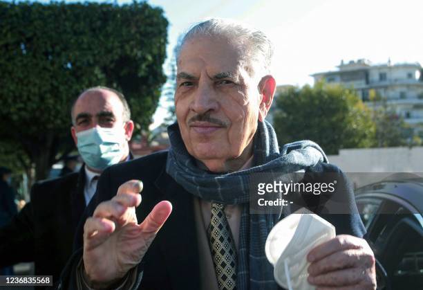 Algeria's Council of the Nation leader Salah Goudjil arrives to cast his vote during municipal and provincial council elections, at a polling station...
