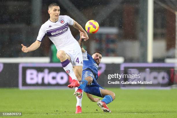 Patrick Cutrone of Empoli FC battles for the ball with Nikola Milenkovic of ACF Fiorentina during the Serie A match between Empoli FC and ACF...