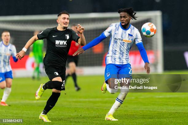 Andi Zeqiri of FC Augsburg and Jordan Torunarigha of Hertha BSC battle for the ball during the Bundesliga match between Hertha BSC and FC Augsburg at...