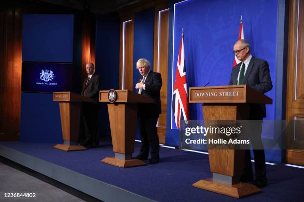 Prime Minister Boris Johnson stands between British Chief Medical Officer for England Chris Whitty and British Chief Scientific Adviser Patrick...