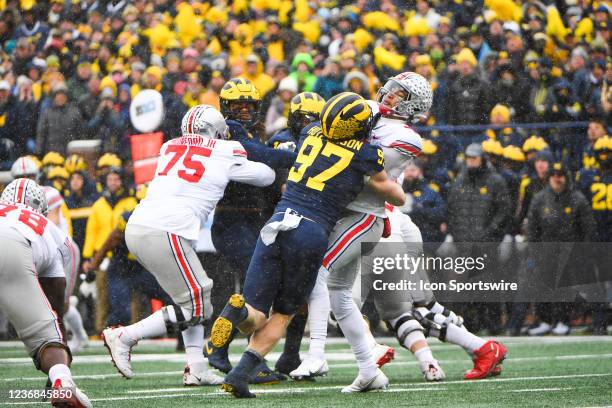 Ohio State Buckeyes quarterback C.J. Stroud gets the ball away just before Michigan Wolverines defensive end Aidan Hutchinson hits him during The...