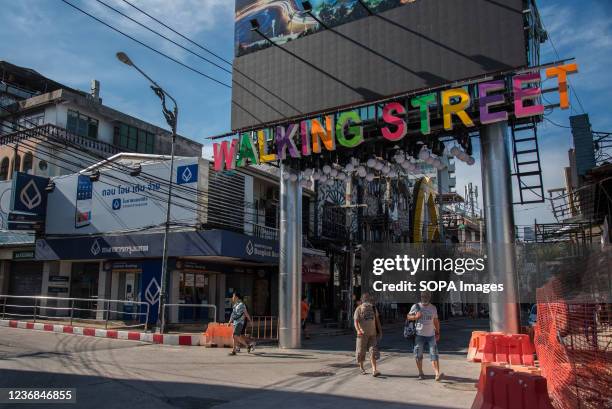 Tourists seen walking in front of the Walking street gate on Pattaya walking street. Pattaya Walking Street the entertainment and nightclub district...