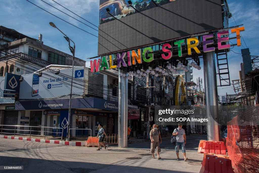 Tourists seen walking in front of the Walking street gate on...