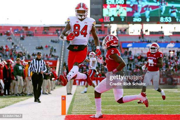 Corey Dyches of the Maryland Terrapins scores a touchdown on a run-in front of Avery Young of the Rutgers Scarlet Knights during the third quarter of...