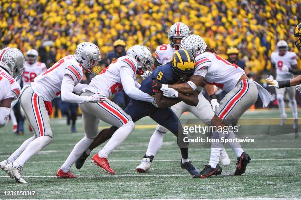 Michigan Wolverines wide receiver Mike Sainristil is gang tackled inside the 10 yard line during The Michigan Wolverines vs the Ohio State Buckeyes...