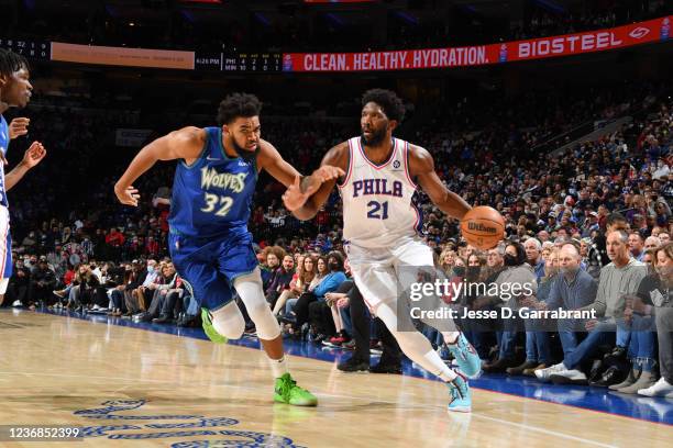 Joel Embiid of the Philadelphia 76ers handles the ball against Karl-Anthony Towns of the Minnesota Timberwolves on November 27, 2021 at Wells Fargo...