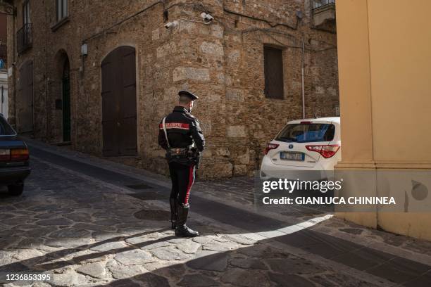 Carabinieri police officer stands on a street on November 18, 2021 in Vibo Valentia, Calabria, where, on October 17 a defendant in the...