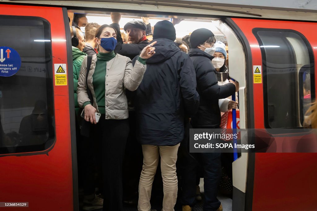 Commuters are seen on a crowded train at Waterloo Station...