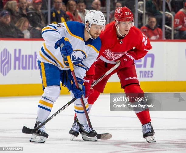 Rasmus Asplund of the Buffalo Sabres and Lucas Raymond of the Detroit Red Wings line up for a face-off in the third period of an NHL game at Little...