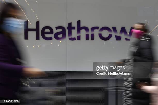 Travellers pass through the international arrivals gate at Heathrow Terminal 5 on November 28, 2021 in London, England. Following the discovery of a...