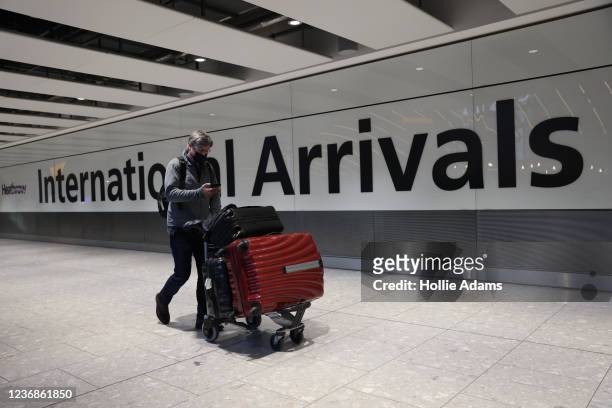 Man wears a face covering at Heathrow Terminal 5 on November 28, 2021 in London, England. Following the discovery of a new Covid-19 variant, whose...