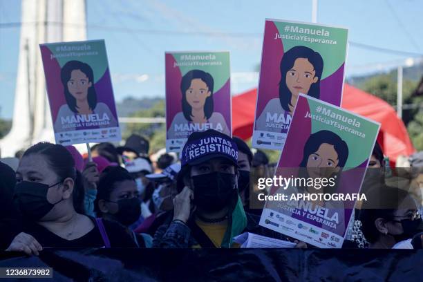 Women hold signs during a protest called by feminist collectives against genre violence on November 28, 2021 in San Salvador, El Salvador. Feminist...