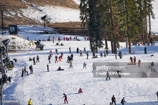 People are seen skiing and snowboarding on a mountain near lake Tahoe in North California. During thanksgiving holiday, a lot of people in the United...