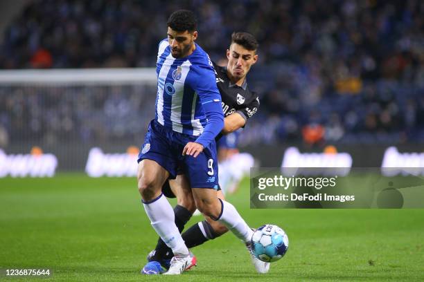 Mehdi Taremi of FC Porto and Andre Almeida of Vitoria Guimaraes SC battle for the ball during the Liga Portugal Bwin match between FC Porto and...