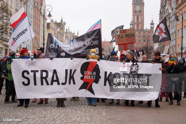 Protesters hold a banner reading "Women's Strike" during a protest in Gdansk. Protesters gathered on the Old Town of Gdansk against tightening...